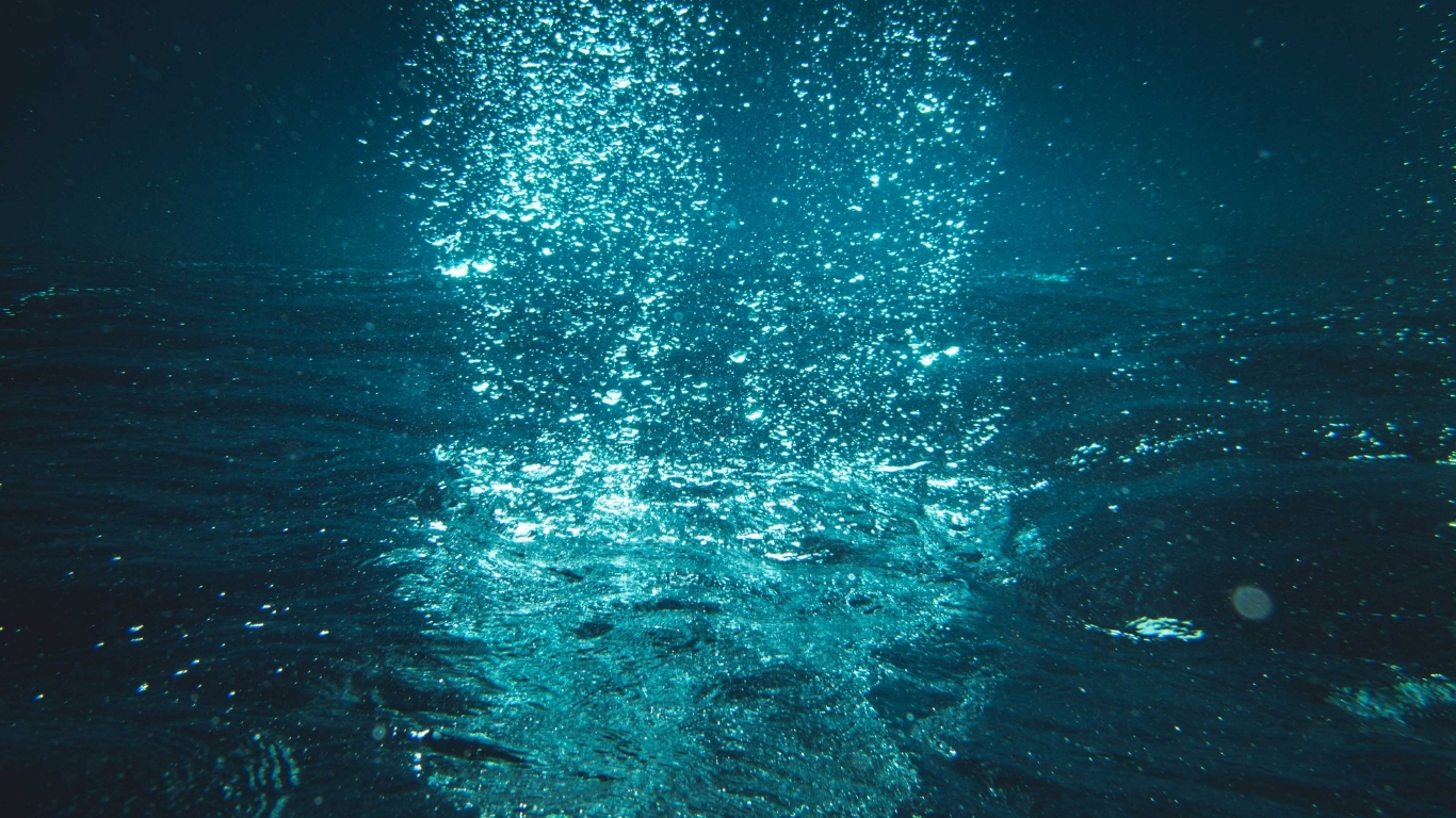 Sunlit sparkling turquoise water surface